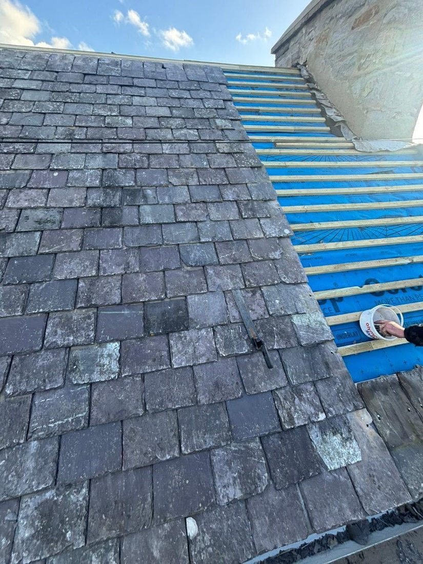Coating being applied to an existing slate roof