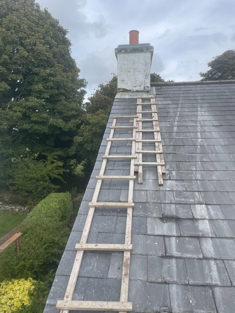 Crawl boards laid up a slate roof to the chimney stack
