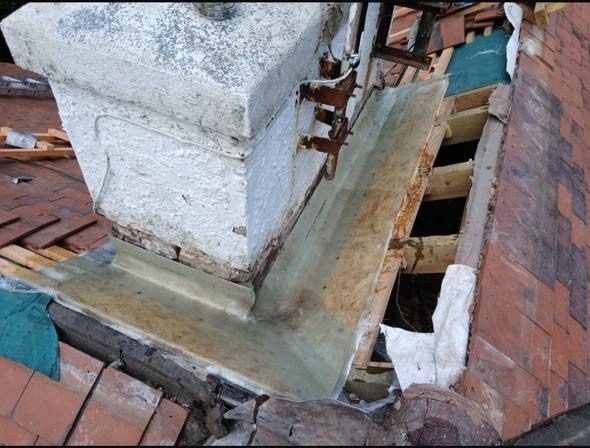 New lead flashing being fitted around a chimney base