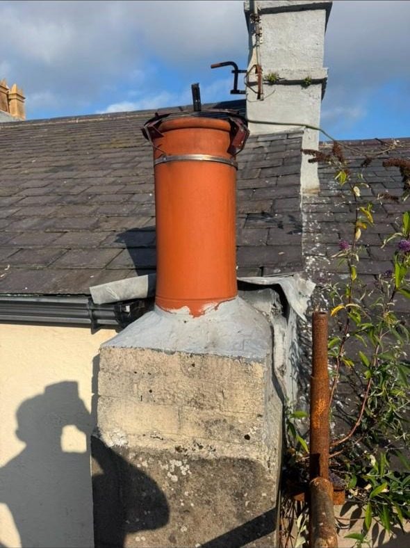 New chimney pot fitted on a rendered stack