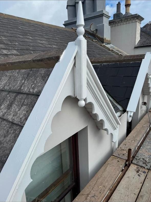 Ornate gable bargeboard freshly repainted white
