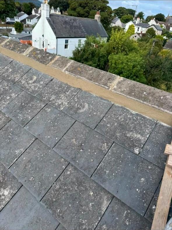 Slate roof with freshly mortared parapet capping