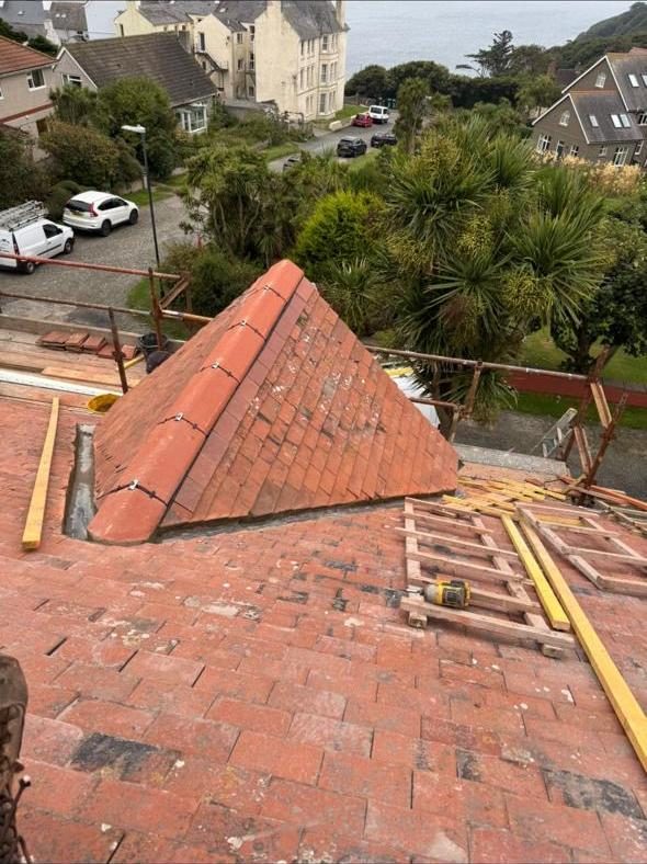 Finished hip roof with new clay tiles overlooking the coast