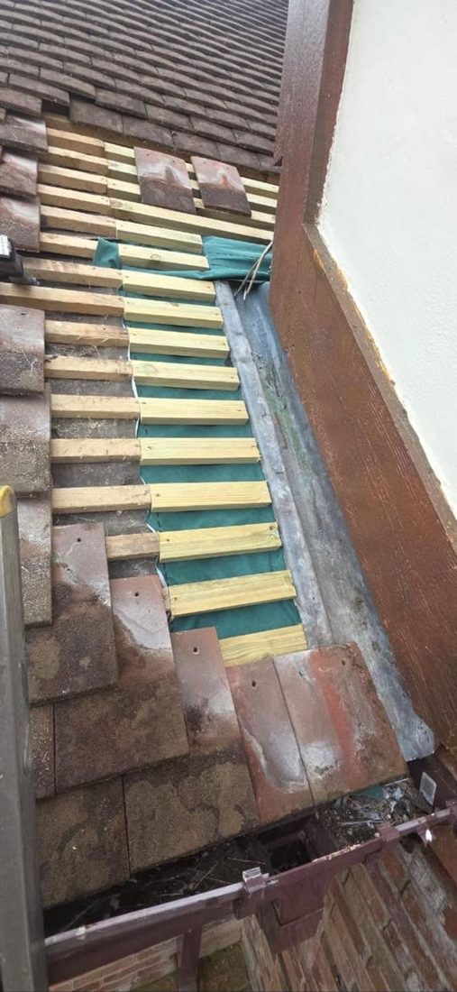 Roof battens and felt being renewed during a repair
